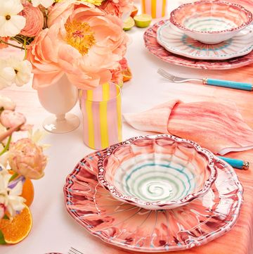 a table with plates and oranges