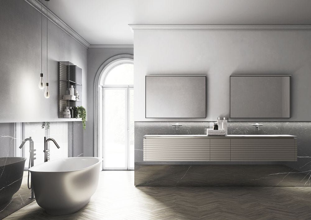 Grey and white bathroom with freestanding bath, twin sink vanity and herringbone floor