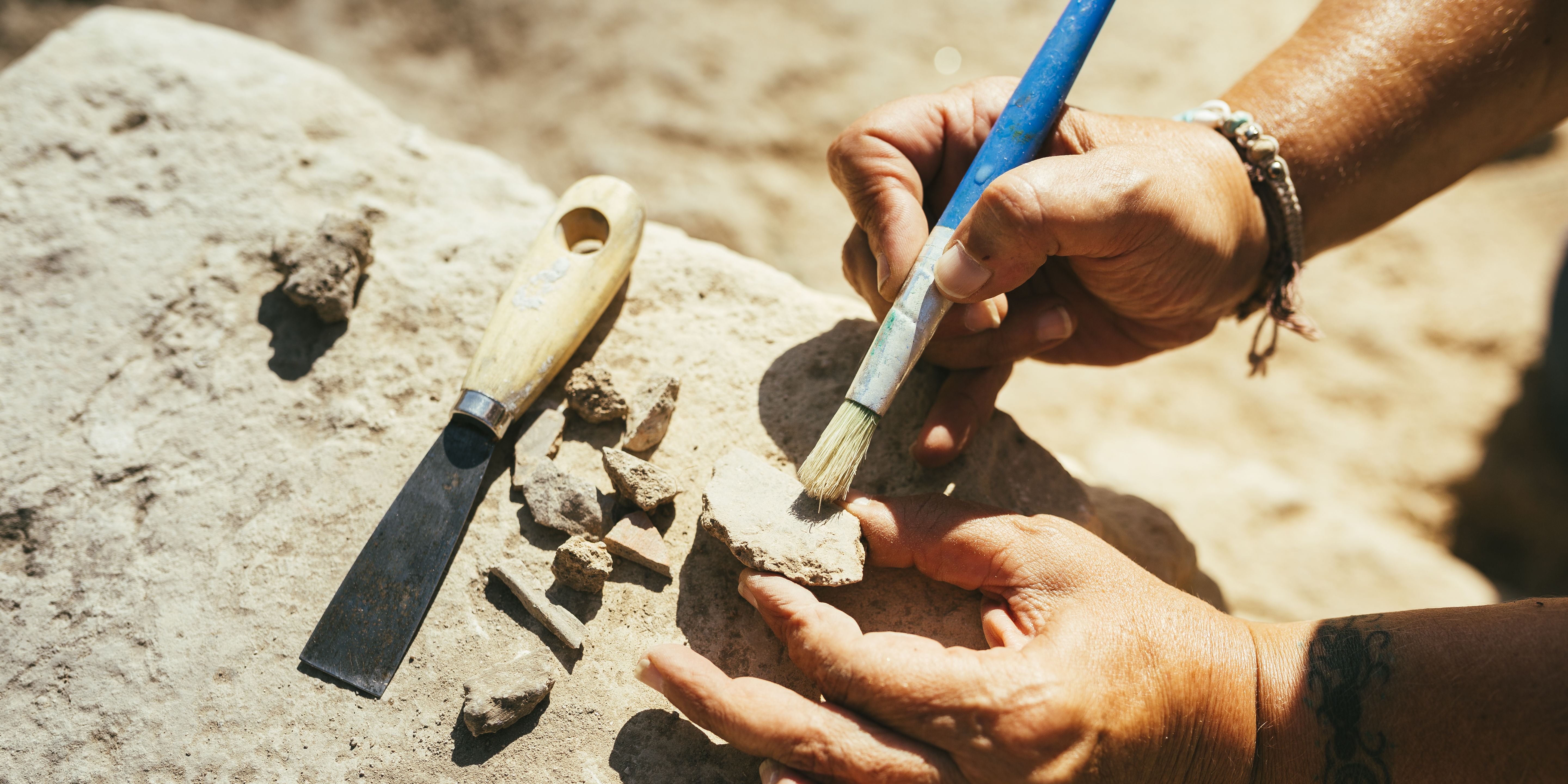 archaeologist-brushing-pottery-on-an-archaeological-royalty-free-image-1747417908.pjpeg