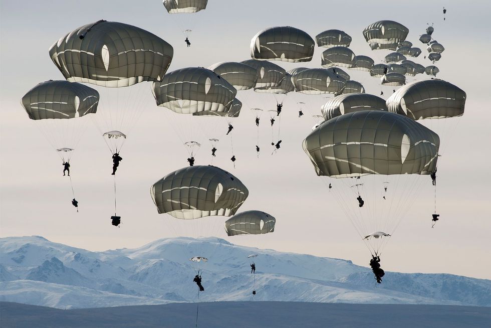 Zon vierhonderd Amerikaanse militairen worden getraind in parachutespringen bij Fort Greely Alaska De oefening waaraan ook Canadese eenheden meedoen moet de troepen voorbereiden op de ontberingen gedurende grote operaties bij extreme kou