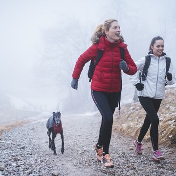 friends jogging in winter with dog