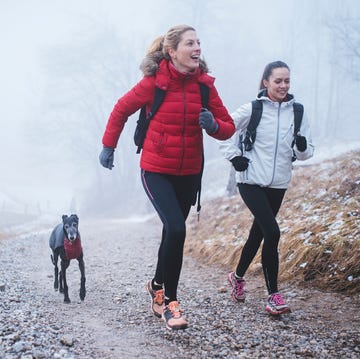 friends jogging in winter with dog