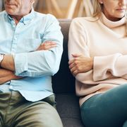 falling out of love  older couple sitting on couch with arms crossed