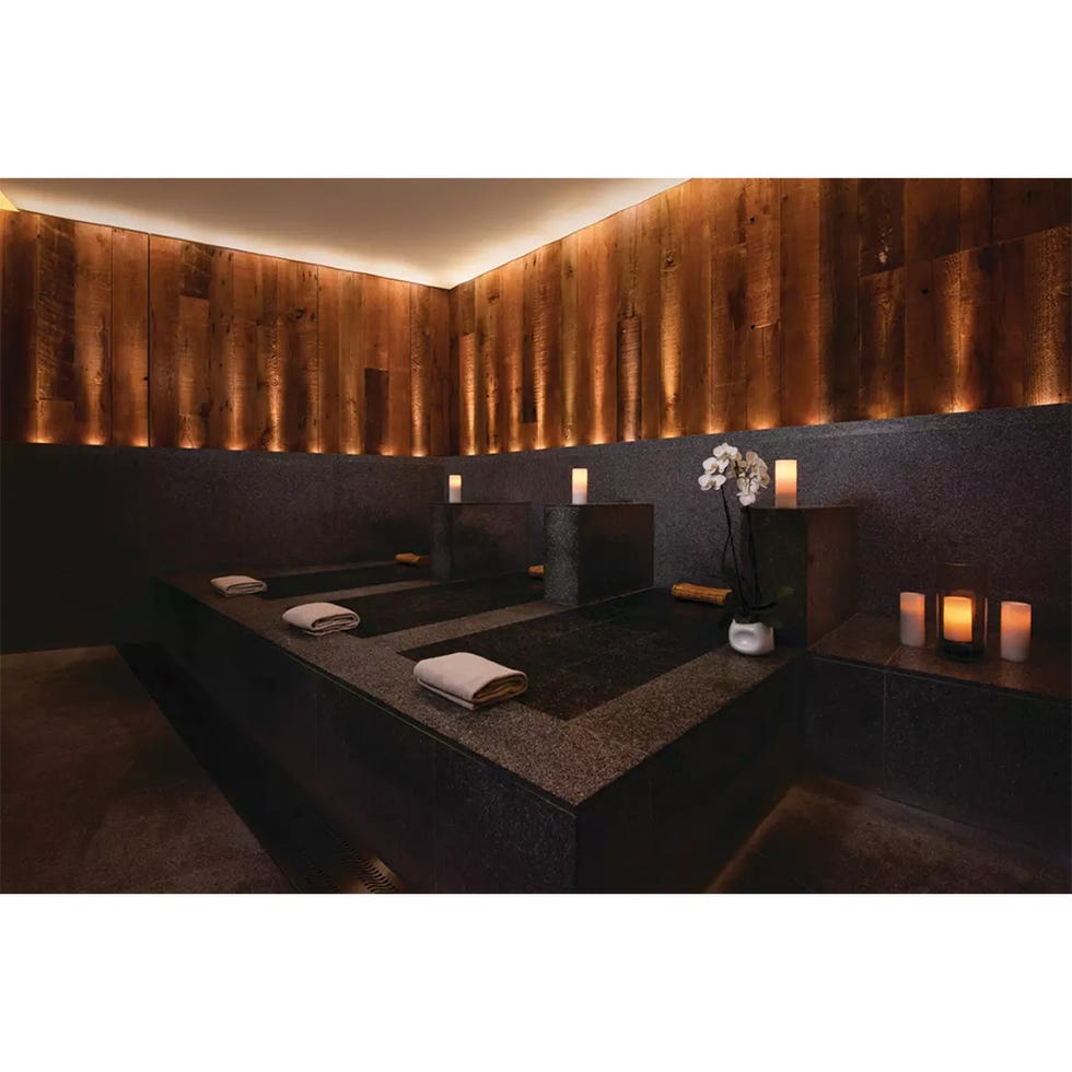 spa relaxation area with stone benches and soft lighting