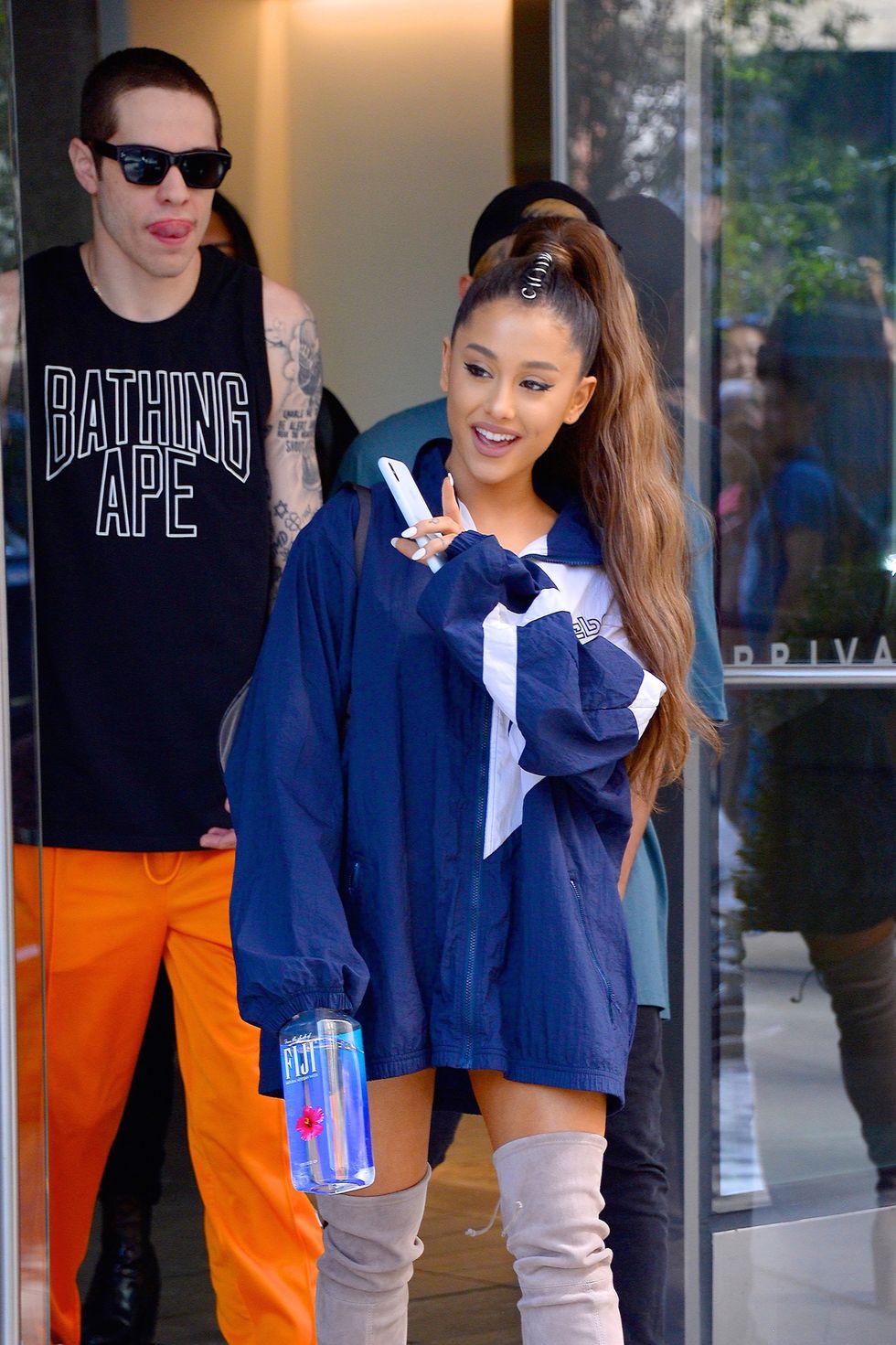 Ariana Grande pairs oversized shirt with thigh highs while