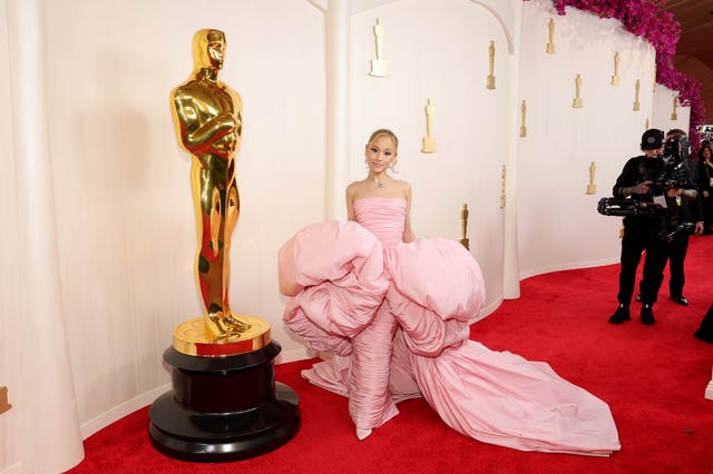 ariana grande poses in pink dress