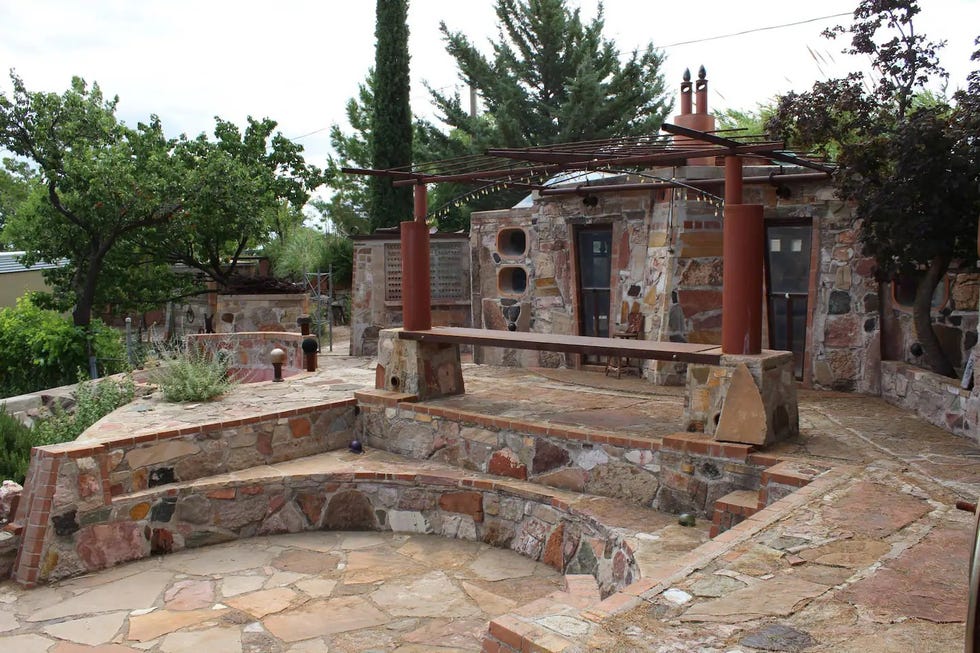 a small building with a stone patio