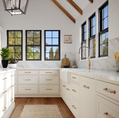 a bank of double hung windows with 4 over 4 divided lites brings fresh air and natural light to a traditional kitchen