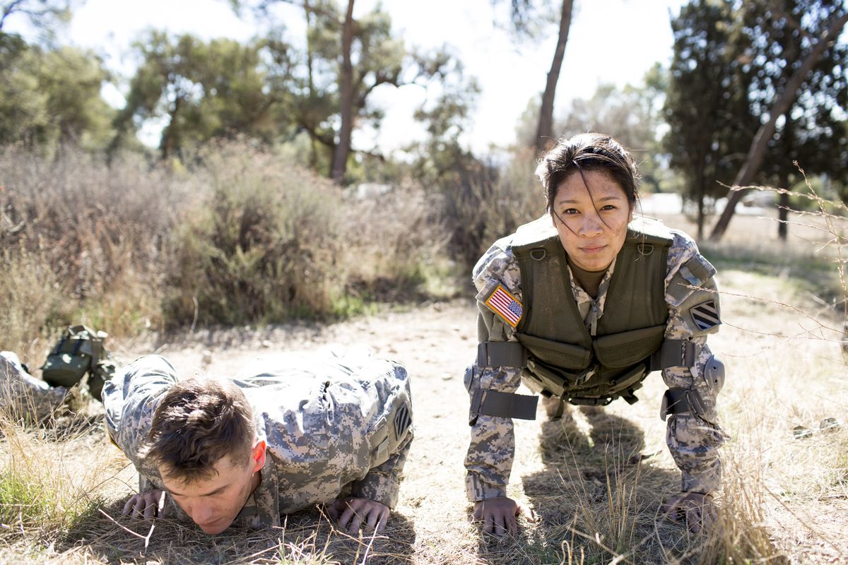 army woman and man doing pushups