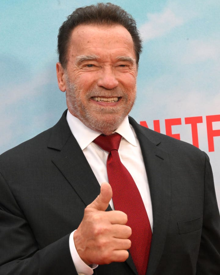 Arnold Schwarzenegger, at the premiere of FUBAR, is one of the world's richest celebrities arnold schwarzenegger giving a thumbs up gesture and smiling