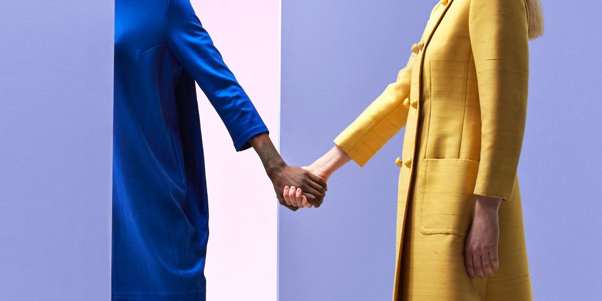 Blue, Yellow, Suit, Gesture, Electric blue, Formal wear, Standing, Interaction, Outerwear, Hand, 