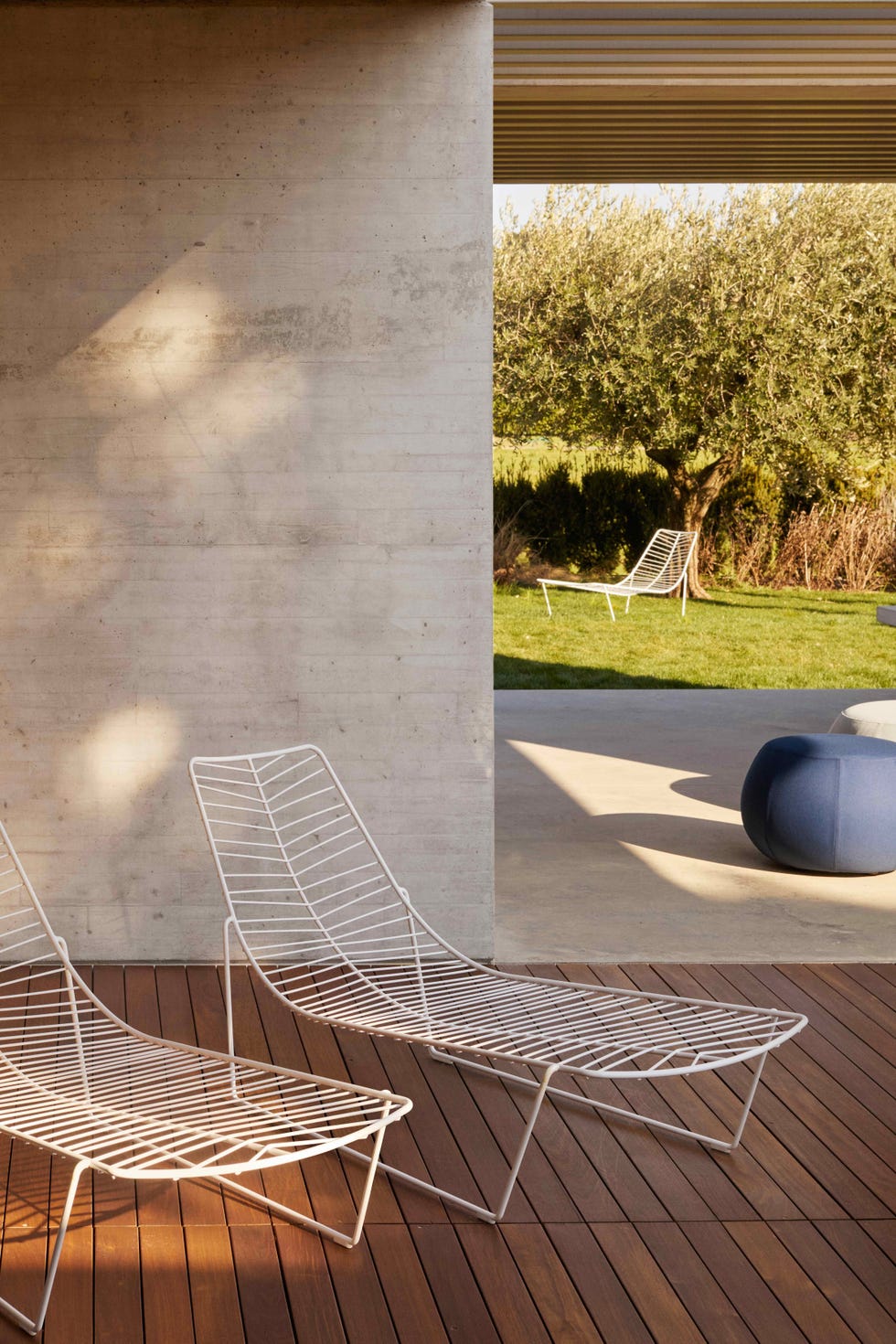 two white sunbeds on decking