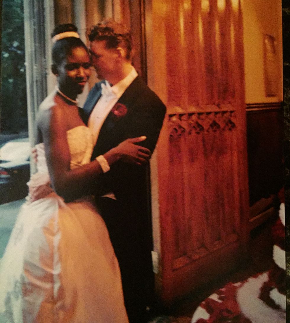 bozoma and peter hugging at their wedding reception