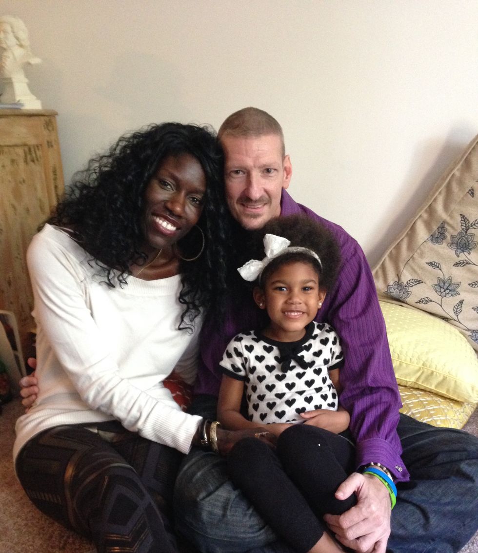 bozoma and peter sitting with their daughter lael