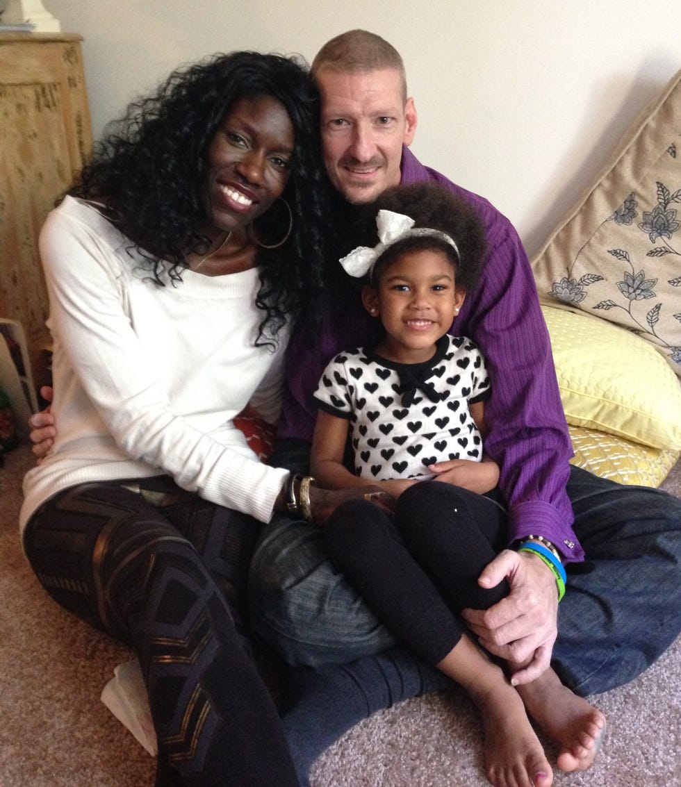 bozoma and peter sitting with their daughter lael