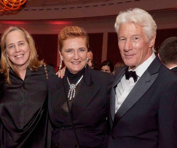 Group of three individuals dressed elegantly at a formal event