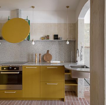 a kitchen with yellow cabinets