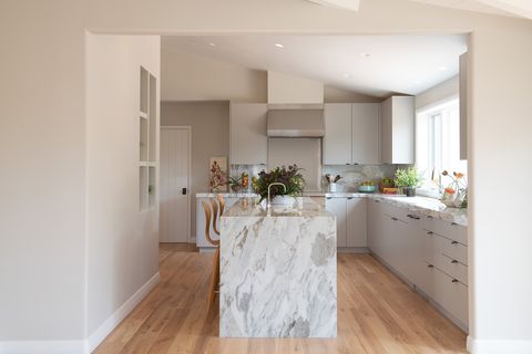 neutral kitchen with marble counters and island