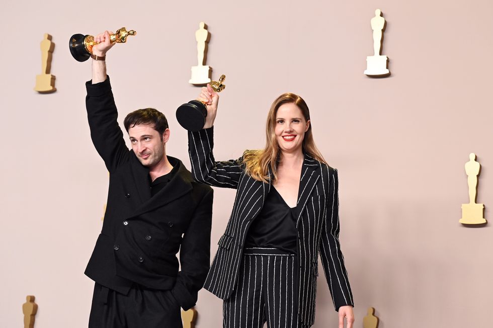 a man and woman holding up trophies