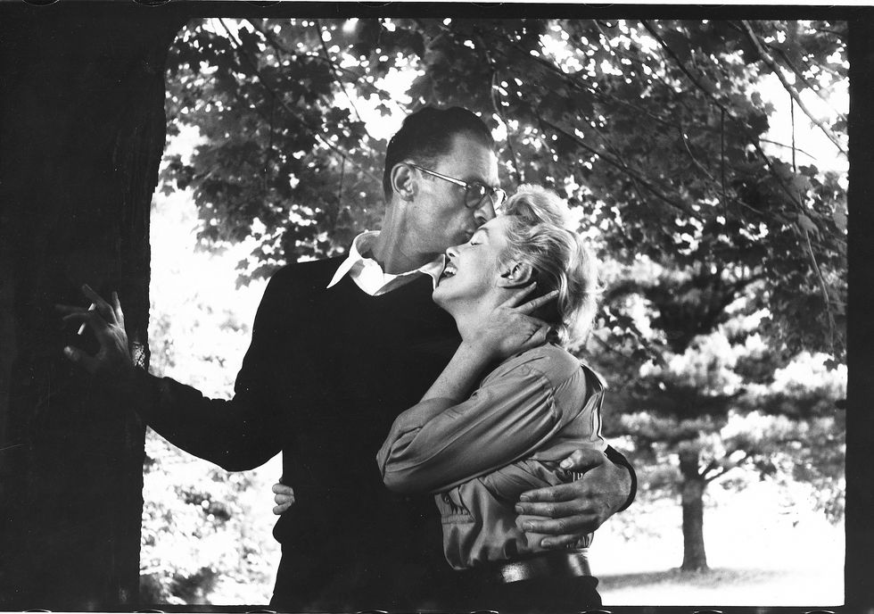 Arthur Miller kissing Marilyn Monroe on the forehead