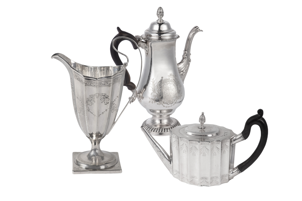 three antique silverware pieces including a teapot a creamer and a sugar bowl