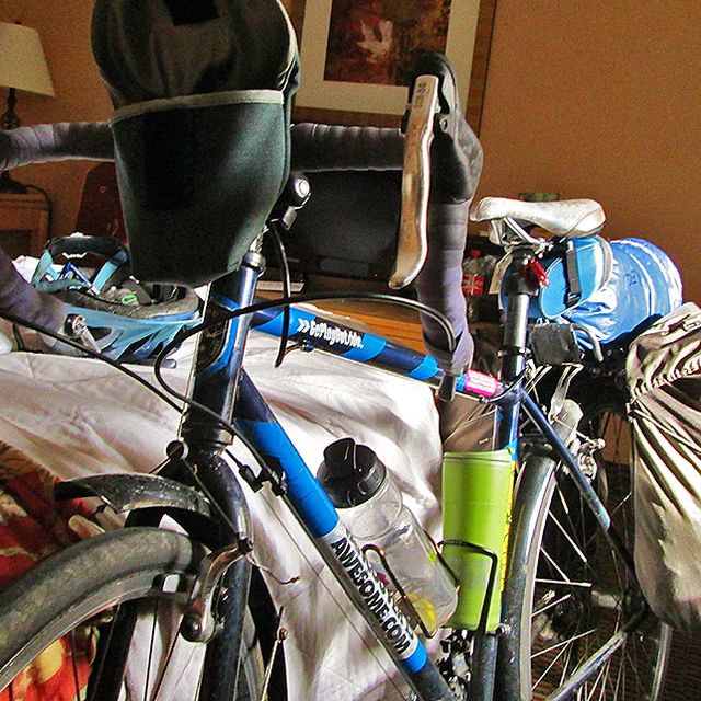 touring bike propped against bed in bedroom