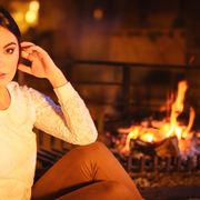 woman by fireplace