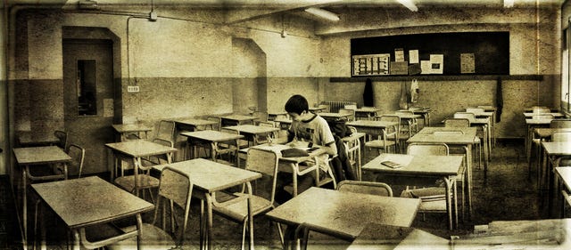 Student writing solo exam.