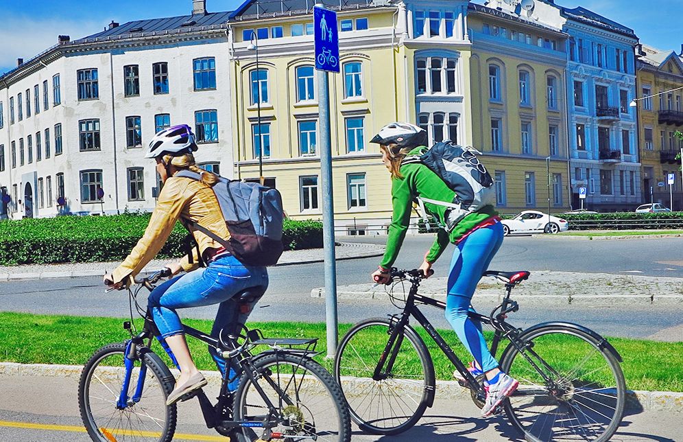 women cyclists riding bike path in Oslo Norway 