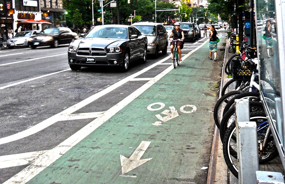 woman cycling in new york city bike lane