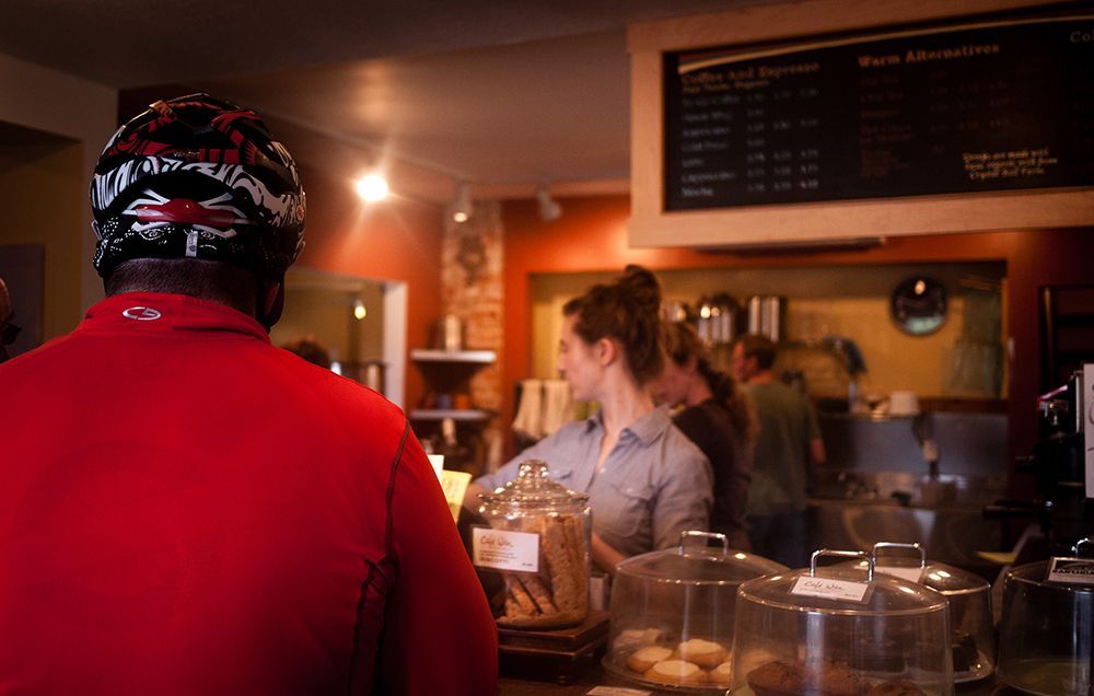 cyclist ordering coffee at a cafe