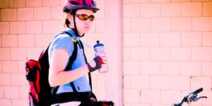 cyclist drinking water from water bottle