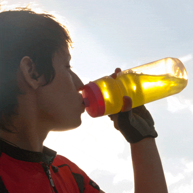 cyclist drinking from colorful water bottle