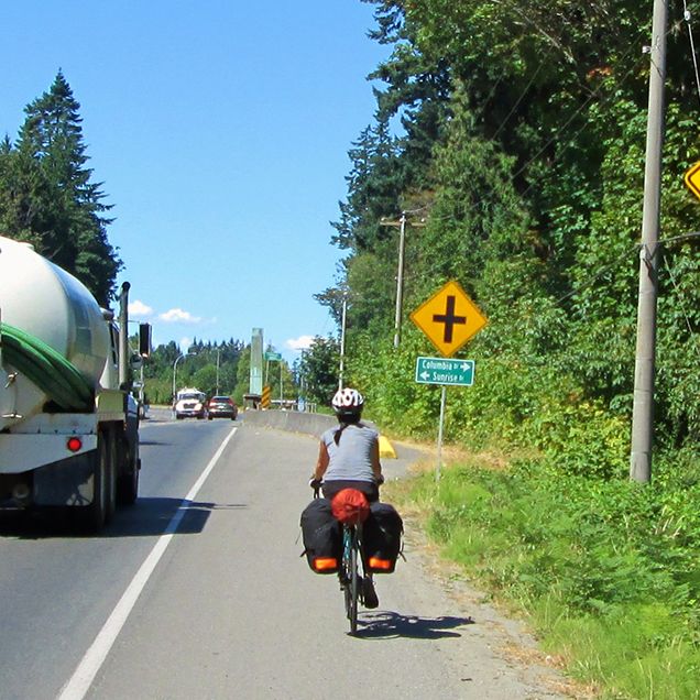 A cyclist near a Share the Road sign. 