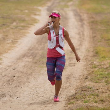 Runner ingesting a gel during a long run. Runner ingesting a gel during a long run.