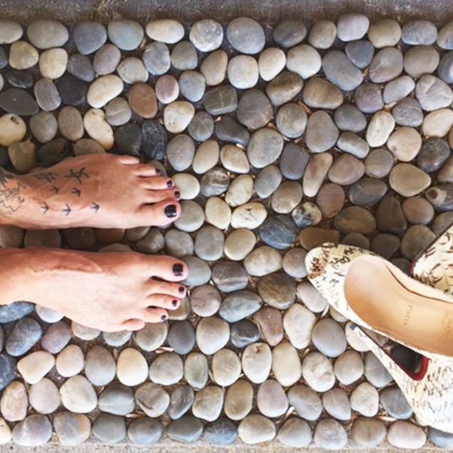 Standing barefoot on cobblestone mat