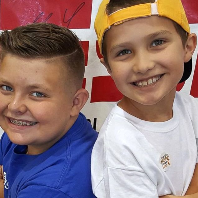 boy sells babseball cards to help friend with cancer