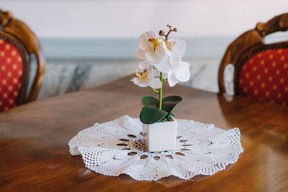 artificial orchid on elegant wooden table