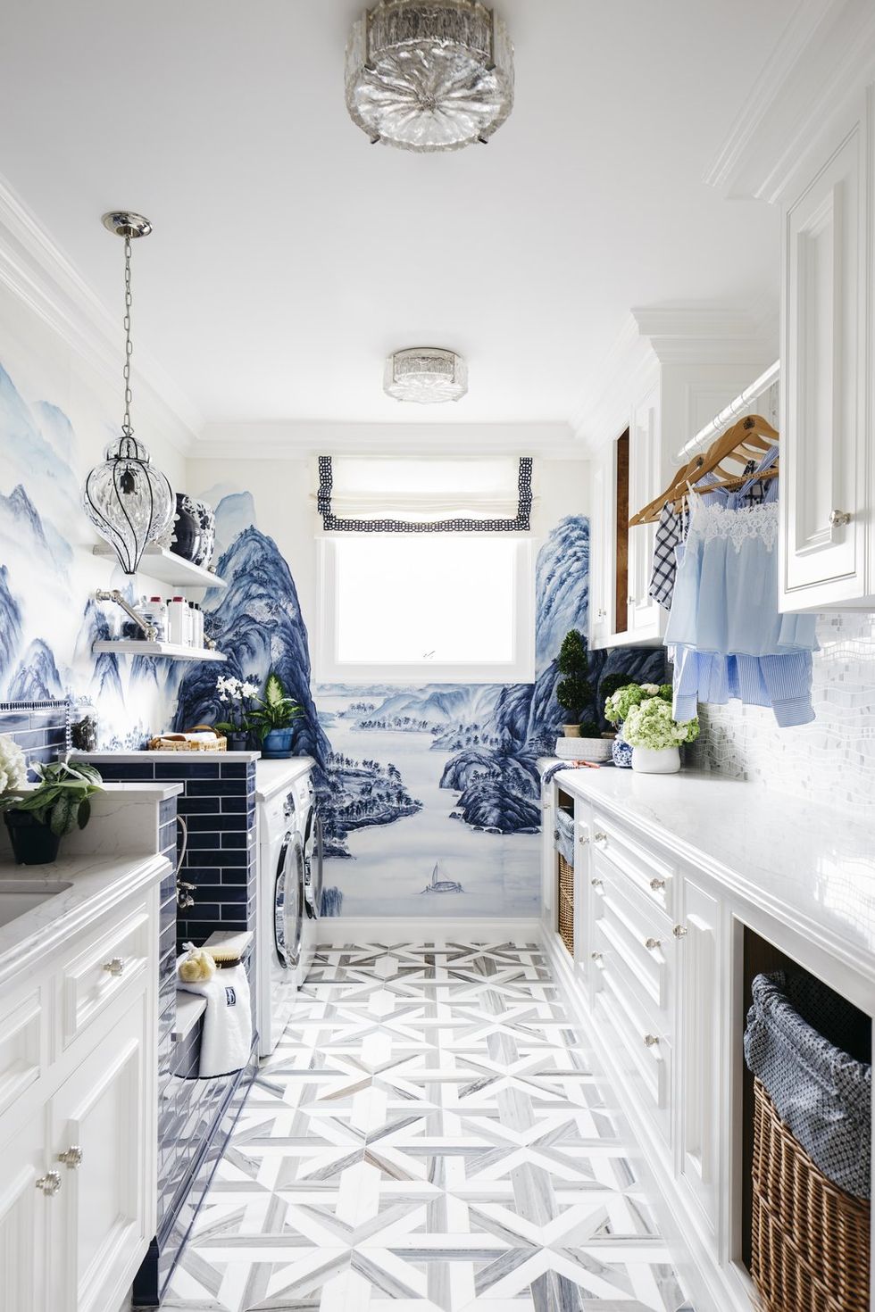 a laundry room with a blue and white mural