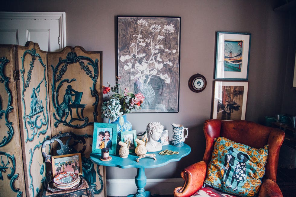 a living room with art and a table