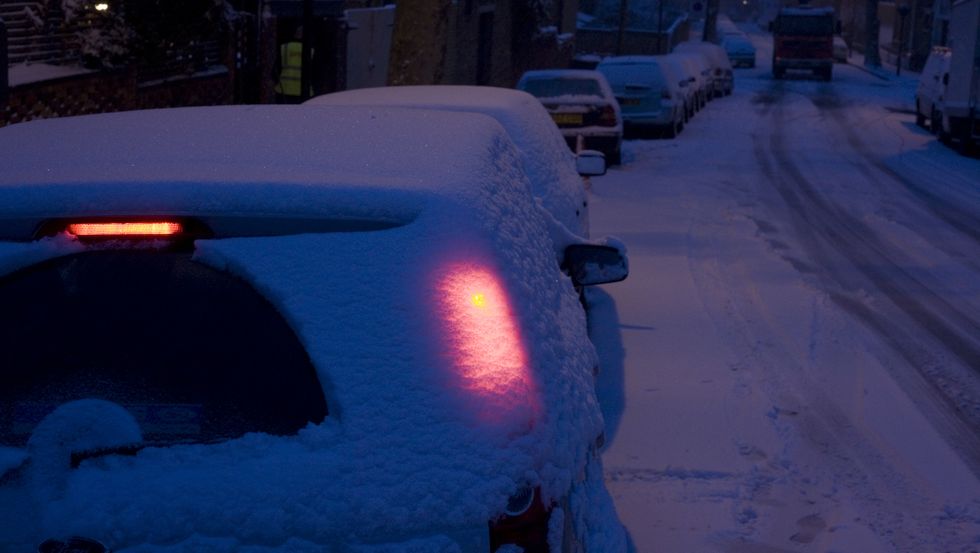 uk   london   red glowing car light in snow