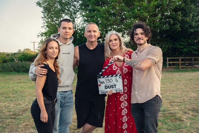 group of people holding a clapperboard on a film set