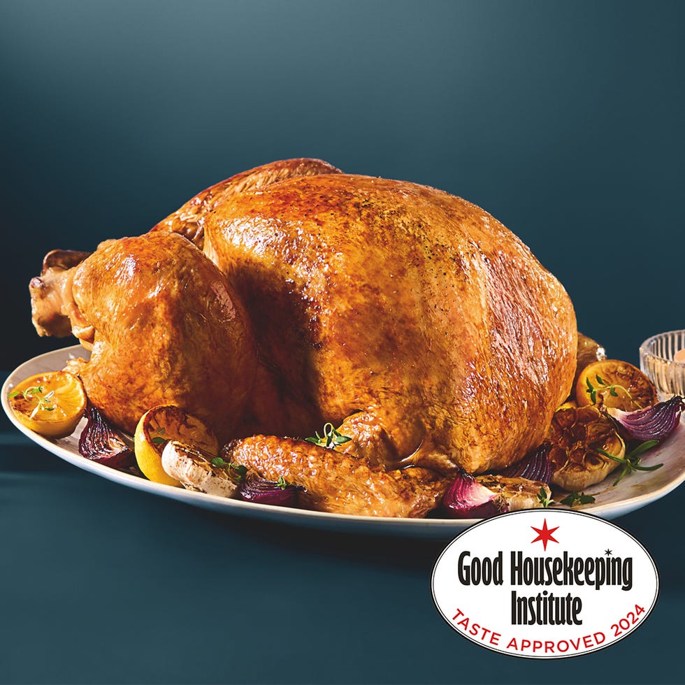 roasted turkey displayed on a platter with garnishes