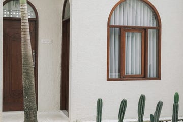 a table with chairs and a table with a tall window