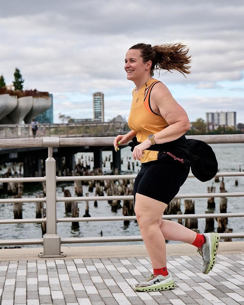 a woman running on a bridge