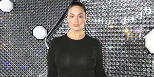 ashley graham wearing a leg slit lbd at the off white rtw aw2024 front row during paris fashion week