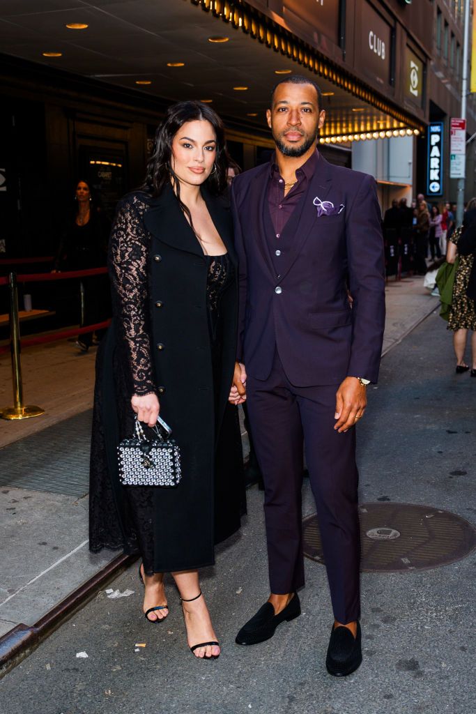 ashley graham and her husband justin evrin ashley is wearing all black and has a lacey dress and sleeves