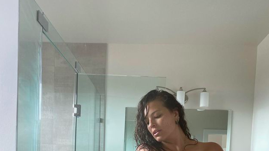 Ashley Graham displays bouncing bosom while jumping on her bed in just  underwear 