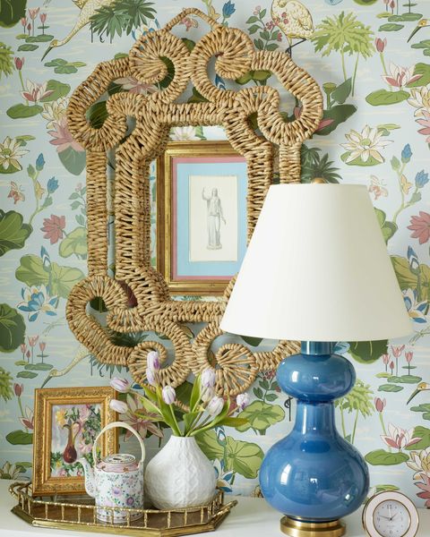 blue table lamp, wicker mirror, lily and water wallpaper