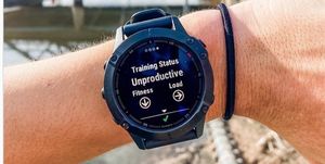 ashley mateo's arm with a garmin watch that says "training status unproductive"